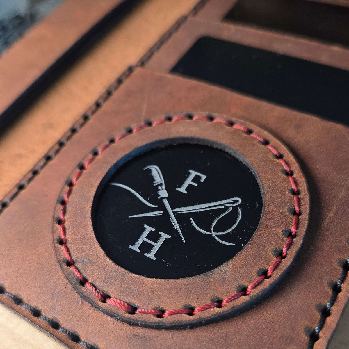 Dienstausweisetui aus Vollnarbenleder braun mit roter Handnaht und schwarzem Coinhalter, verziert mit F und H Symbol