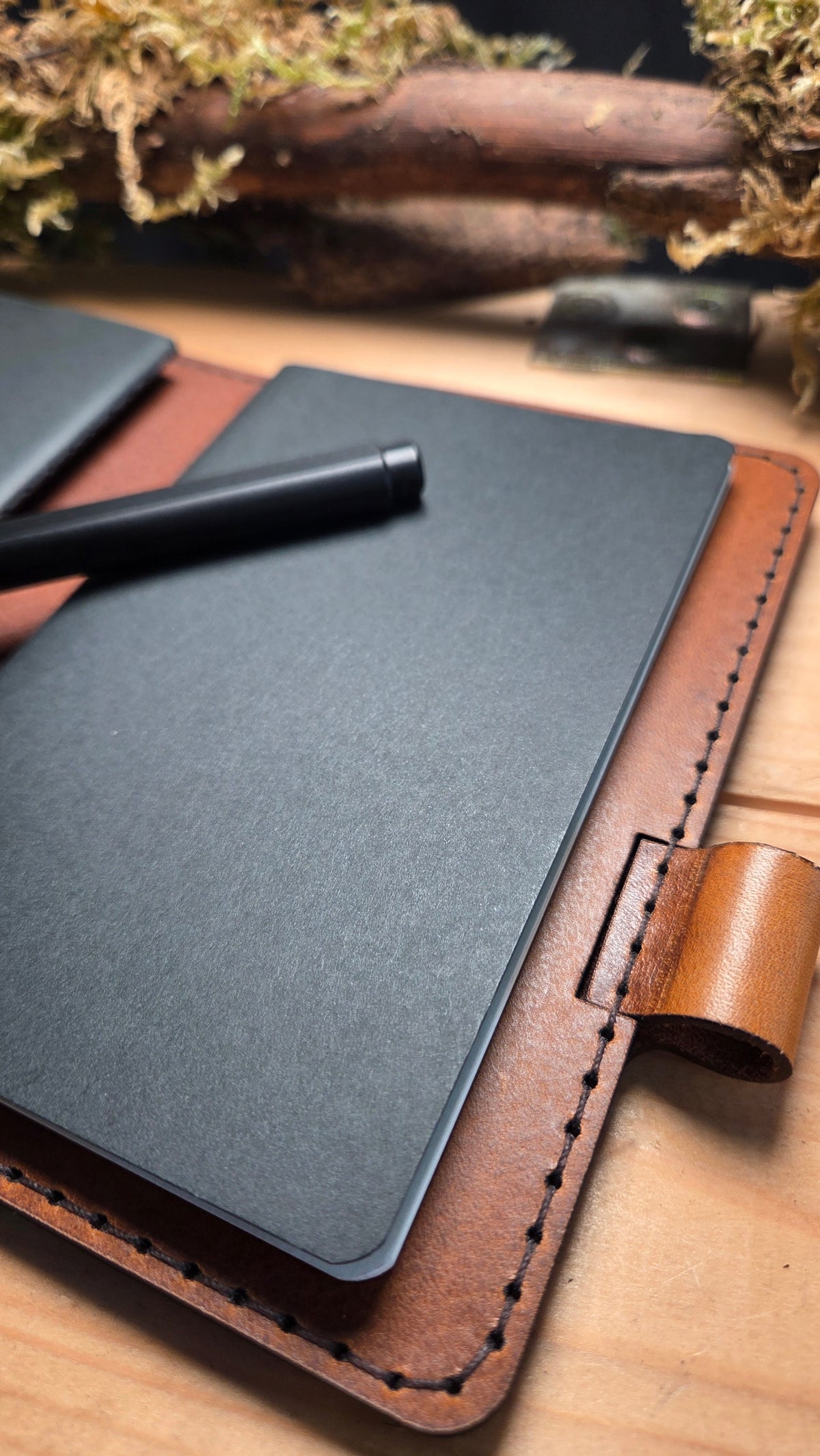 Handgefertigter DELUXE DIN A6 Organizer aus braunem Leder mit integrierter Befestigung für Stifte und einem schwarzen Notizblock