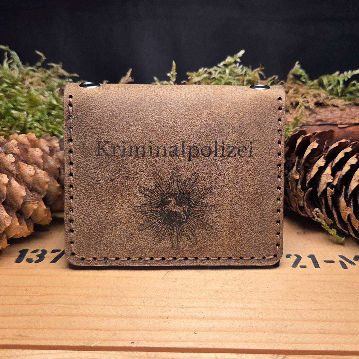 Leder-Dienstausweisetui aus braunem, genarbtem Leder mit dunklen Nähten und geprägtem Kriminalpolizei-Schriftzug samt Emblem
