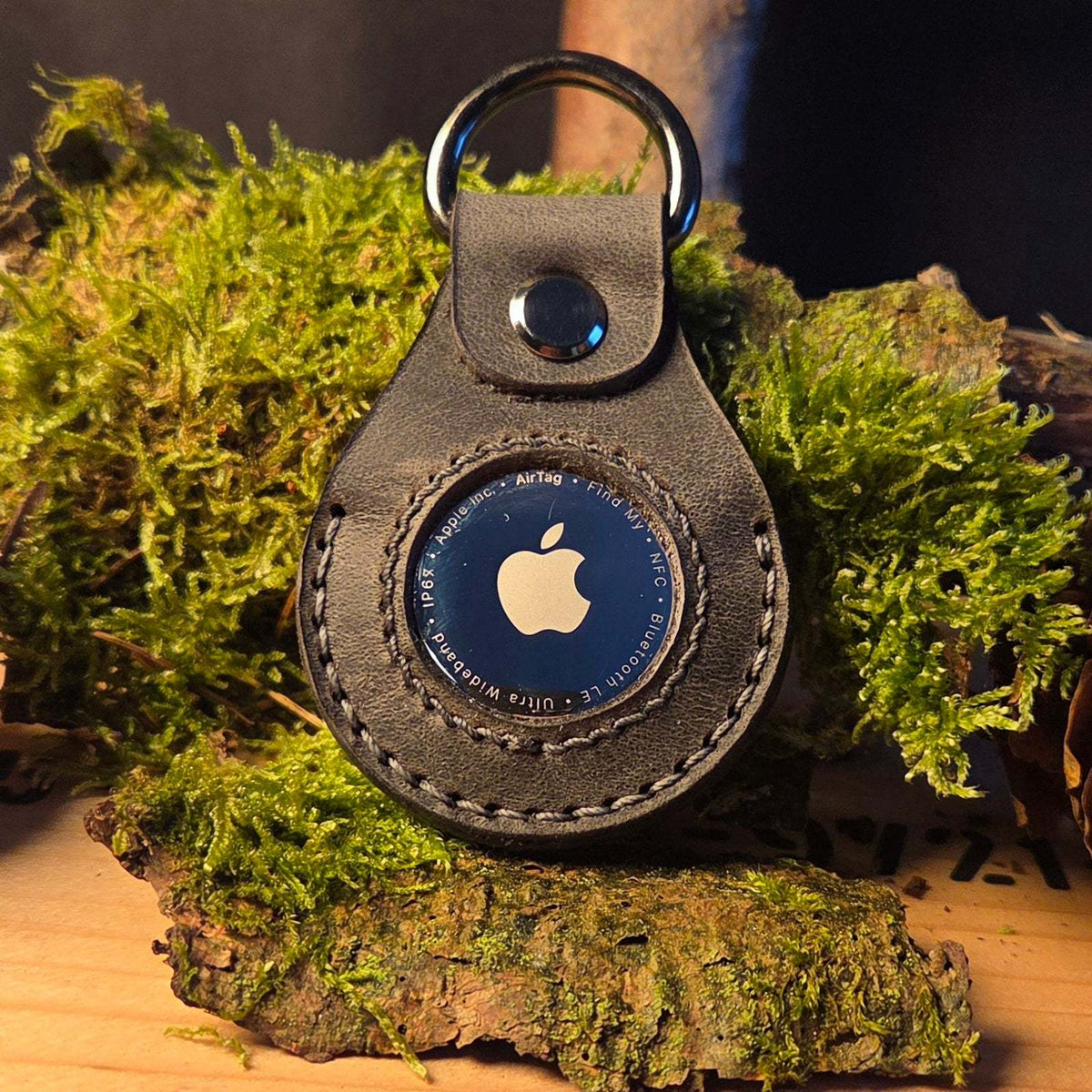 Lederanhänger für Apple Air Tag aus schwarzem Büffelleder mit handgenähter Ziernaht und automatischem Verschluss mit D-Ring